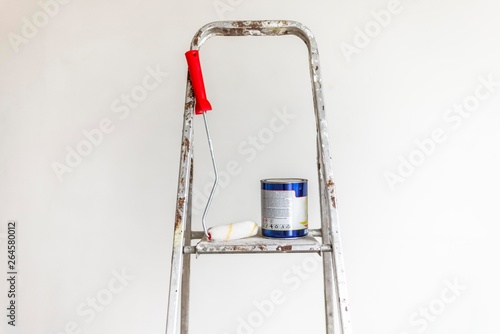 painting roller with color can on metal ladders. 