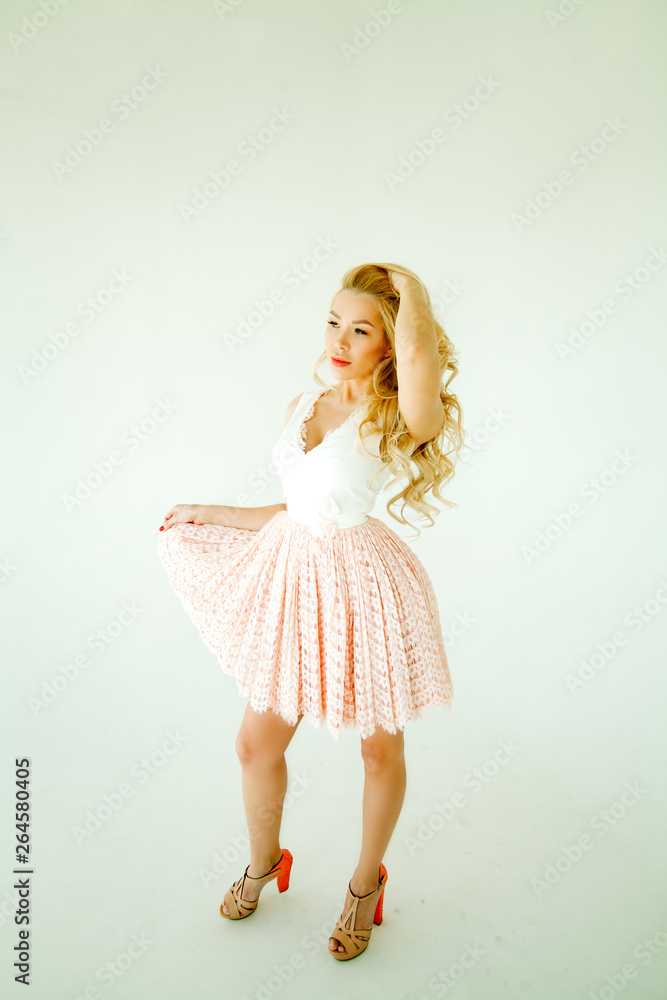girl model blonde with a wreath of flowers on her head in pink dress isolated on white background girl model blonde with a wreath of flowers on her head in pink dress isolated on white background