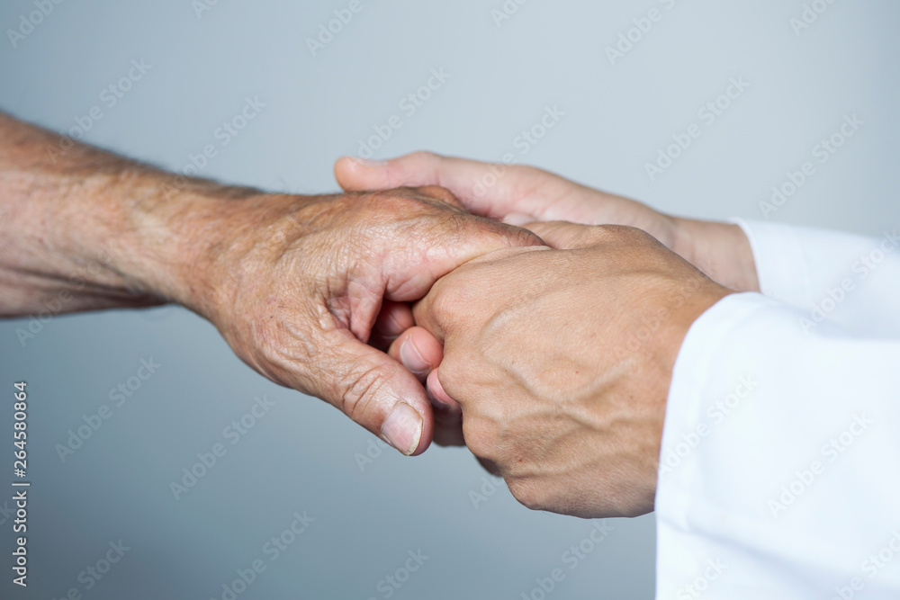 Fototapeta premium man moving the hand of a senior patient