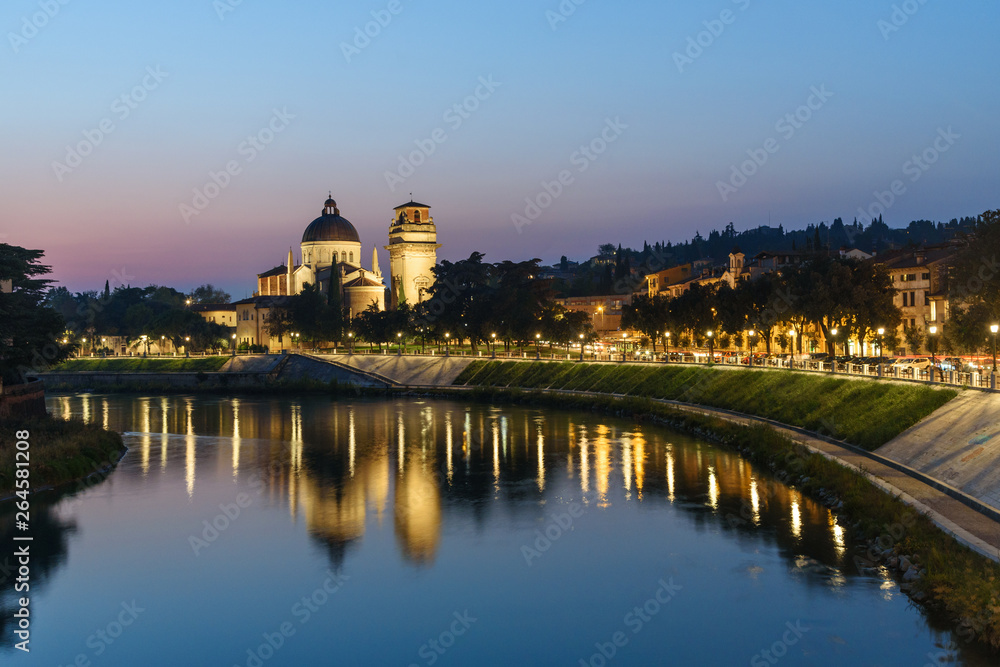 View from Ponte Pietra on Adige River and city at night. Verona. Italy