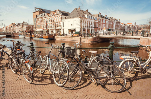 Bicycles parked on bridge through river of historical european town. the Netherlands. © radiokafka