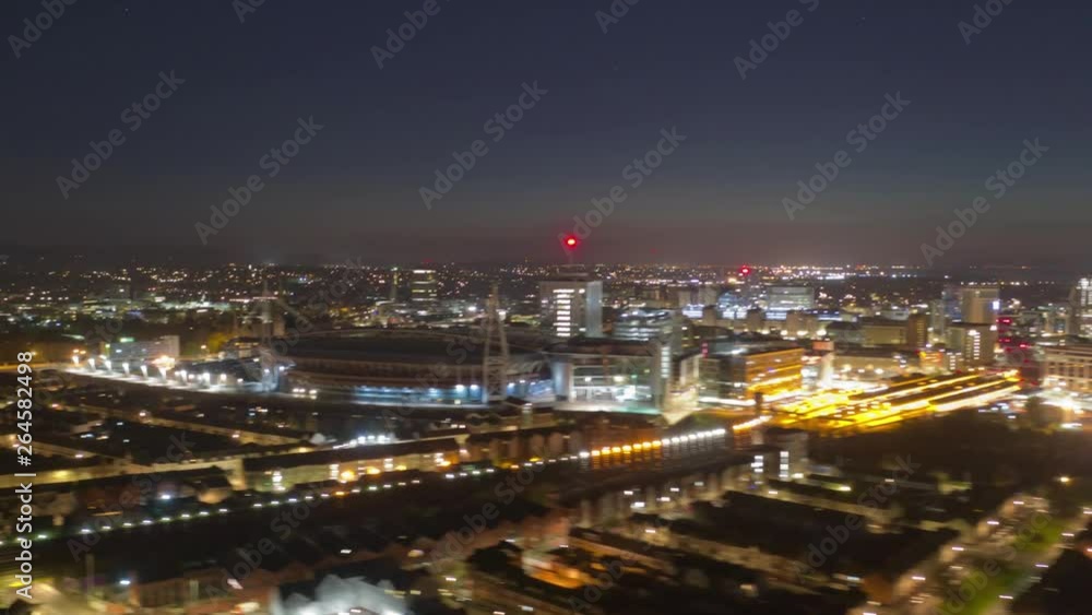 Aerial drone night hyperlapse facing east tracking over Cardiff city Principality Millennium Stadium toward Cardiff Castle and Bute park. Produced from DNG raw stills on DJI Mavic 2 Pro Aerial drone night hyperlapse facing east tracking over Cardiff city Principality Millennium Stadium toward Cardiff Castle and Bute park. Produced from DNG raw stills on DJI Mavic 2 Pro
