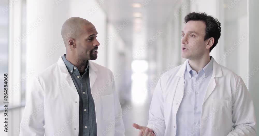 Doctors in a hospital discussing patient treatment Doctors in a hospital discussing patient treatment