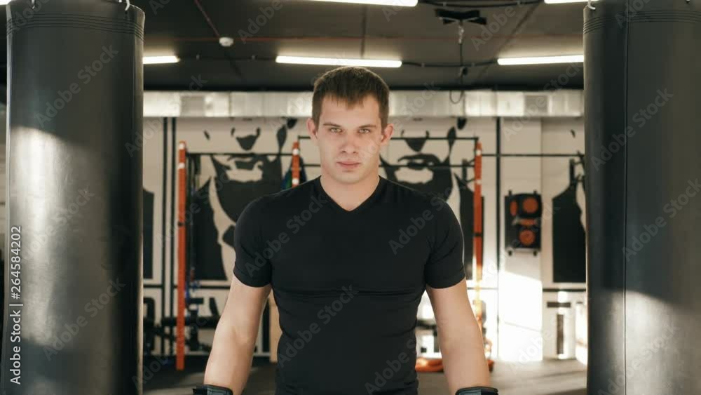 Portrait of boxer posing in gym in gloves fighter mma close up serious man. Portrait of boxer posing in gym in gloves fighter mma close up serious man.