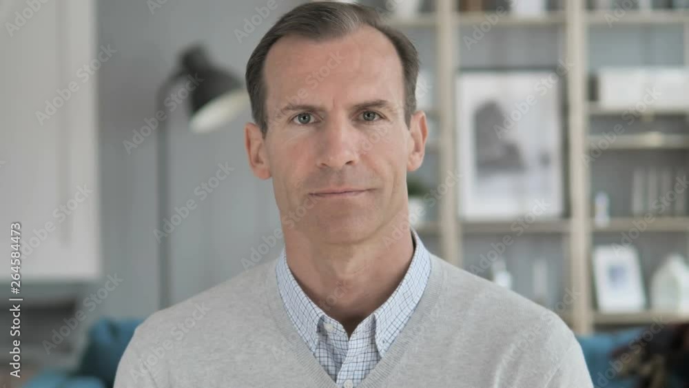 Portrait of Serious Middle Aged Man Looking at Camera Portrait of Serious Middle Aged Man Looking at Camera