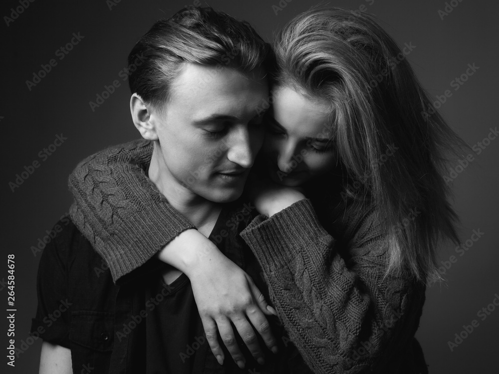 Young woman and young man are hugging. Black and white Young woman and young man are hugging. Black and white