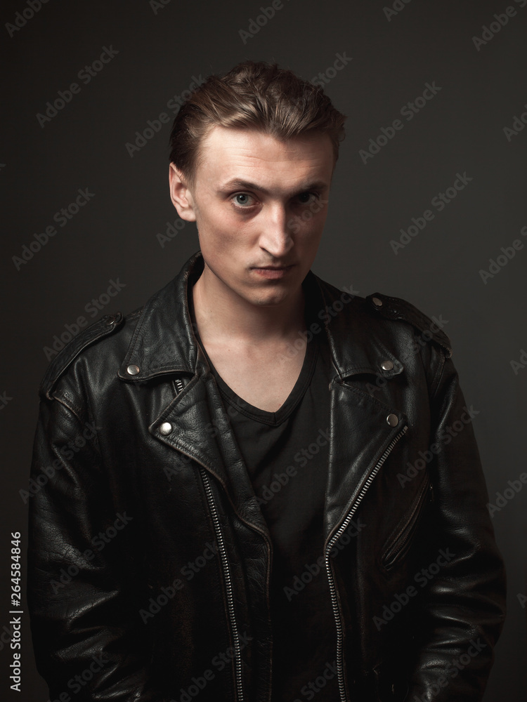 Portrait of the serious handsome young man in leather jacket. Portrait of the serious handsome young man in leather jacket.