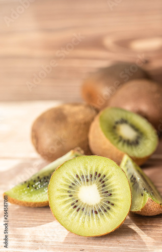Tasty ripe kiwi on table