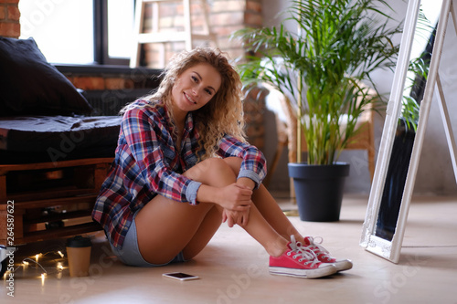 Pretty smiling woman is sit...