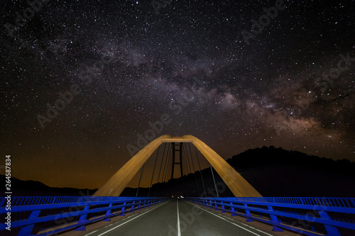 A beautiful view of the Milky Way and the starry sky at a bridge at the Embalse de La Fuensanta in Castilla La Mancha. photo