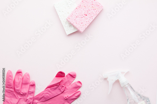 spring cleaning supplies on a pink background with copy space © sianc