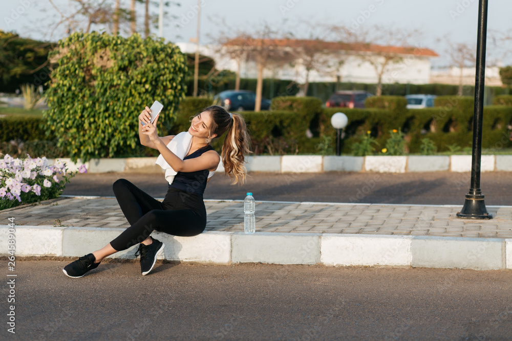 Fototapeta premium Making selfie portrait of joyful sportswoman 