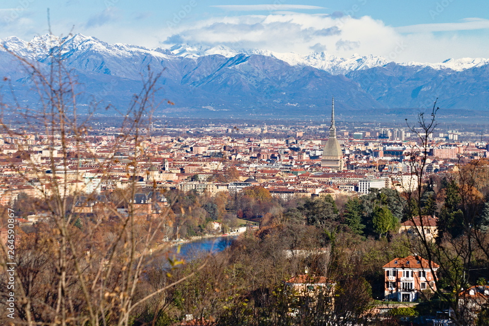 Panorama of Turin, overlooking the city center and the Mole Antonelliana, a backdrop of snow-capped mountains 
