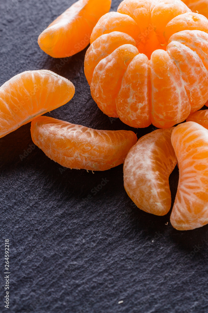juicy mandarin on a dark stone background