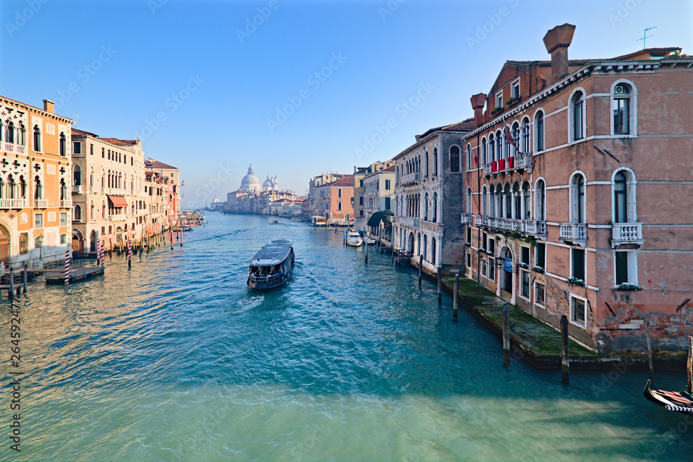Fototapeta premium View of the Grand Canal in Venice, Italy, from the Ponte dell'Accademia, with a ferry crossing the canal