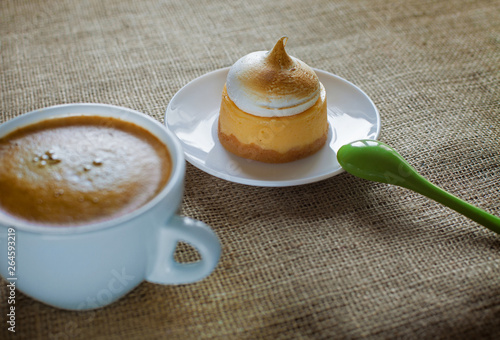 Delicious lemon cakes with merigue, cup of coffee photo