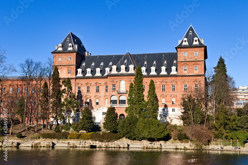 Valentino Castle in the Valentino Park on the Po river, Turin, Piedmont, Italy, bright blue sky spring morning