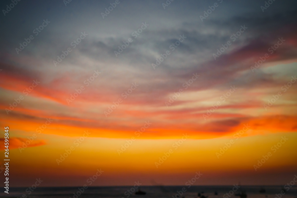 Scene of sunset at sea with cloudy red sky and boats in the water. Tourism Background Scene of sunset at sea with cloudy red sky and boats in the water. Tourism Background