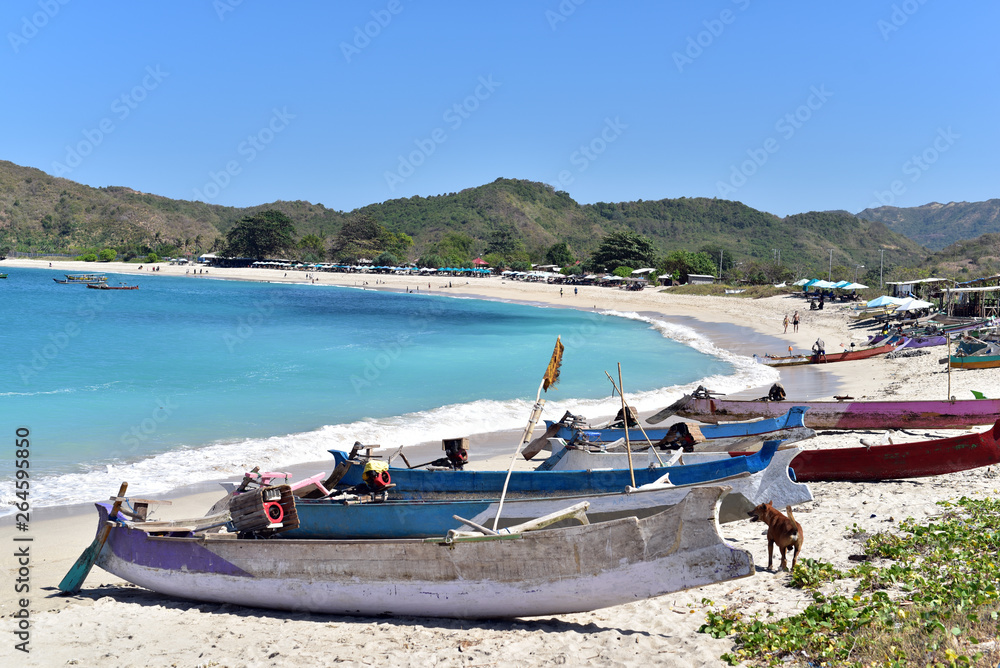 Fishing boats at Pantai Selong Belanak Beach on a sunday afternoon in Lombok Island, Indonesia
