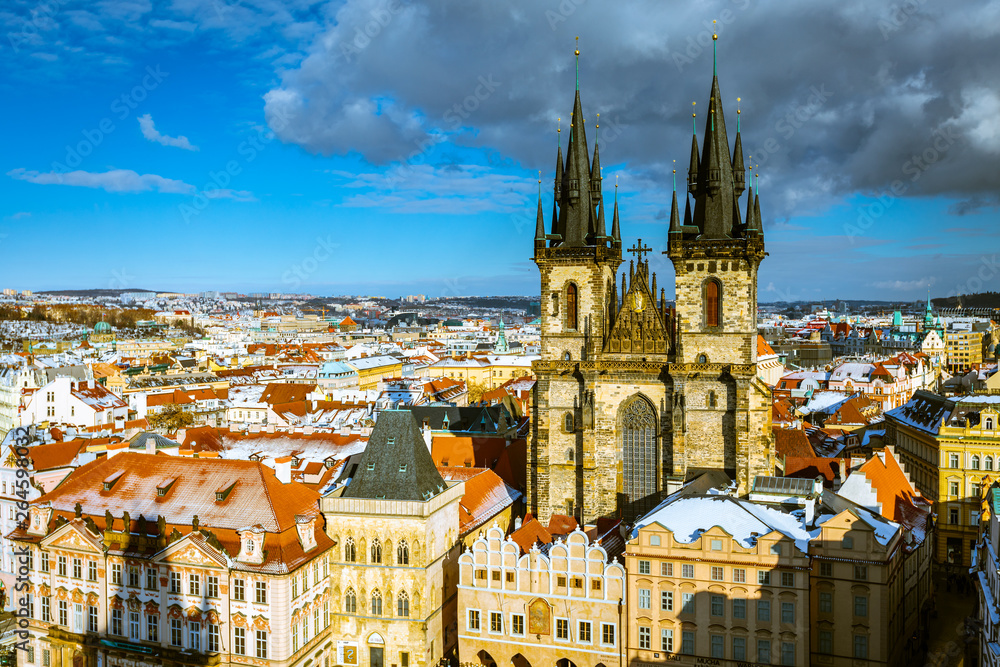Fototapeta premium Tyn church Prague at winter time with snow on roof tops
