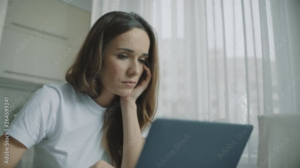Tired woman working on laptop computer at home. Businesswoman working on laptop Tired woman working on laptop computer at home. Businesswoman working on laptop