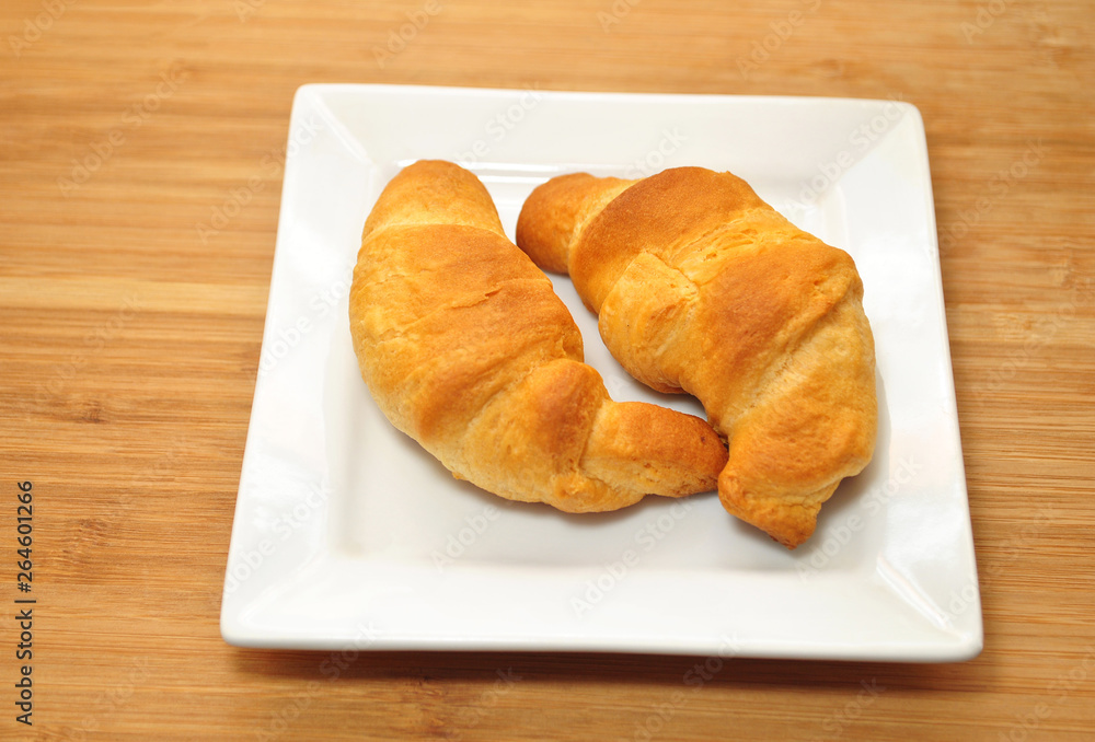 Two Fresh Baked Organic Croissant Rolls On a Plate Two Fresh Baked Organic Croissant Rolls On a Plate