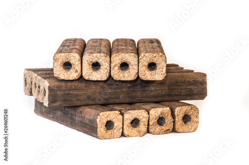 Fuel briquettes folded in rows on a white background. Wooden  briquettes are an environmentally friendly fuel source that are used to start a fire. They are made by pressing of dry sawdust.