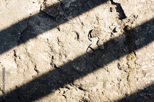 Uneven stone surface with diagonal shadow lines