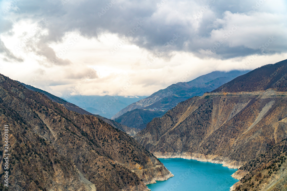 Obraz premium The fantastic view of river with mountains under a blue sky with clouds.