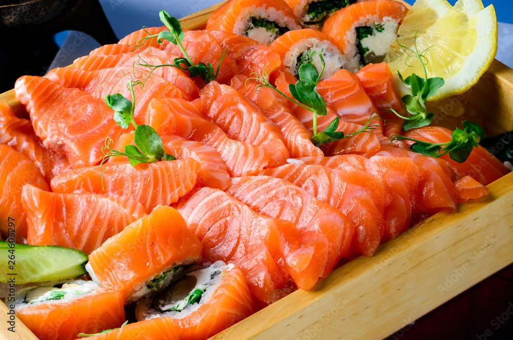 Salmon raw sashimi on brown Japanese traditional dish on black table. Close up. Salmon raw sashimi on brown Japanese traditional dish on black table. Close up.