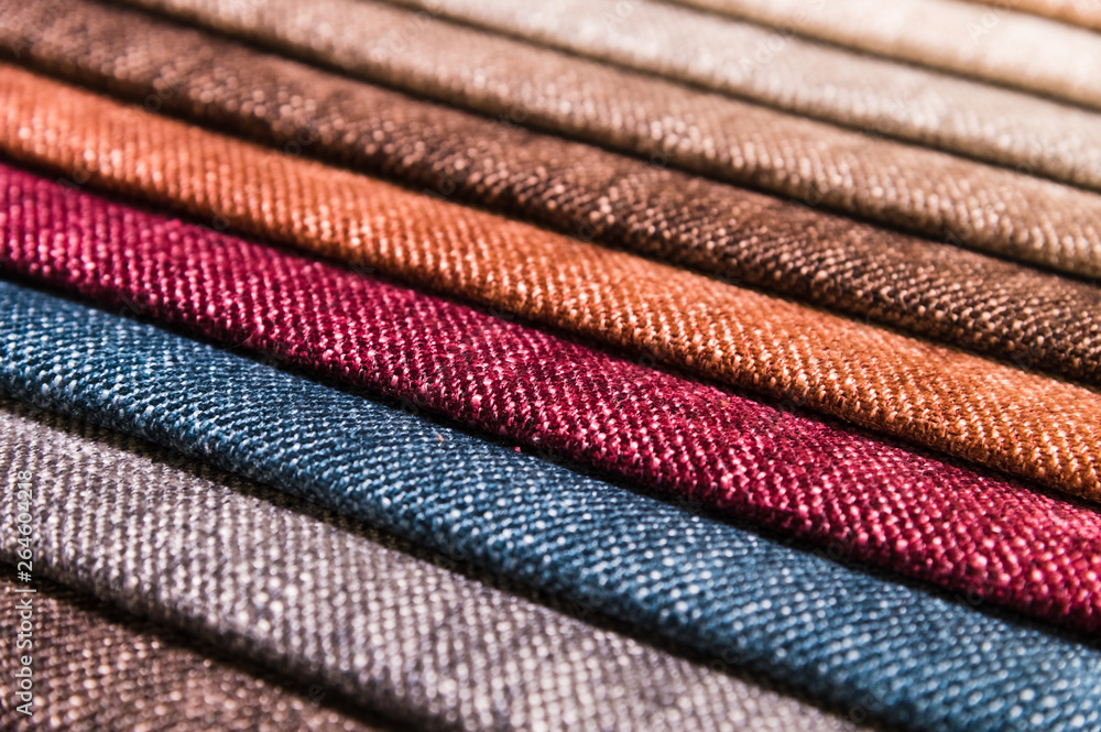 Close-up diagonal lines of textile upholstery in samples to select the color and fabric of the furniture. Abstract multicolored background Close-up diagonal lines of textile upholstery in samples to select the color and fabric of the furniture. Abstract multicolored background