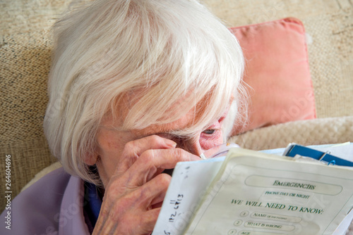 Valokuva Visually impaired elderly woman with magnifyer