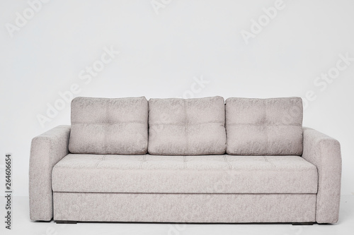 Light grey classic sofa with three pillows isolated at white background