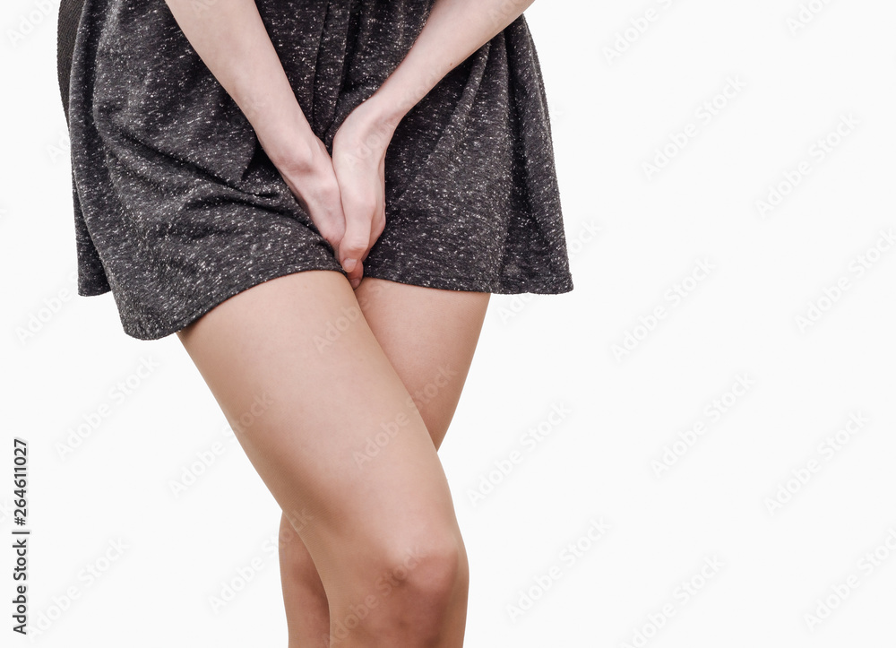 Pelvic thigh young woman with hands holding pressing her crotch of the lower abdomen. Medical or gynecological health problems Pelvic thigh young woman with hands holding pressing her crotch of the lower abdomen. Medical or gynecological health problems