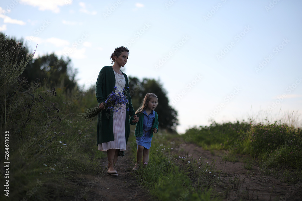 Mother with daughter walking on a road Mother with daughter walking on a road