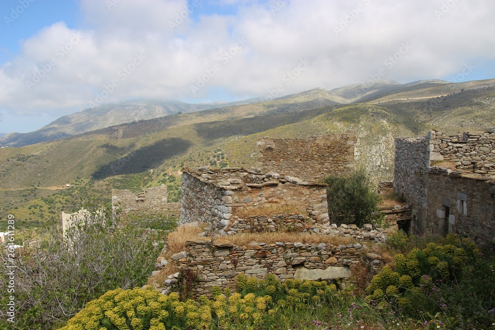 Obraz premium Panoramic view of the ruined town Vathia and surrounding landscape, in spring. In the Inner Mani, Peloponnese, Greece, South-east Europe. It was built in the 18th and 19th century and is a great tou