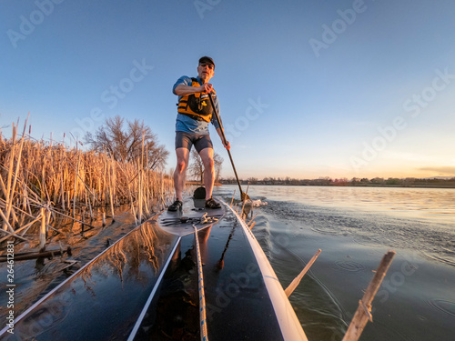 athletic senior man on paddleboard