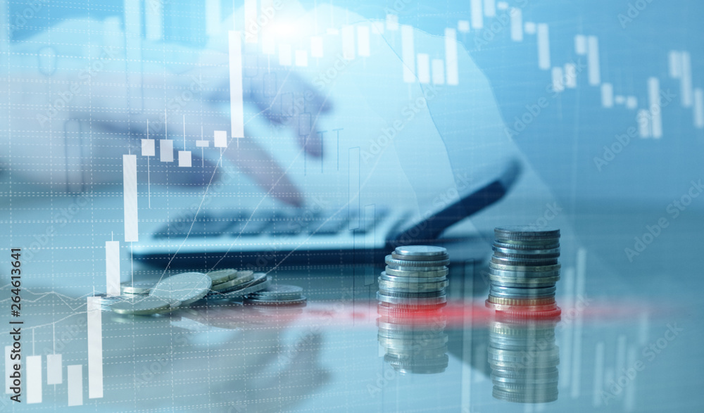 Financial graph chart and rows of coins with calculator.