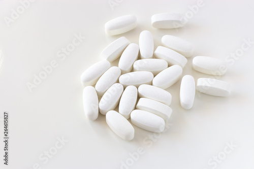 Close up white Calcium carbonate or Vitamin and mineral pills tablets isolated on white background.