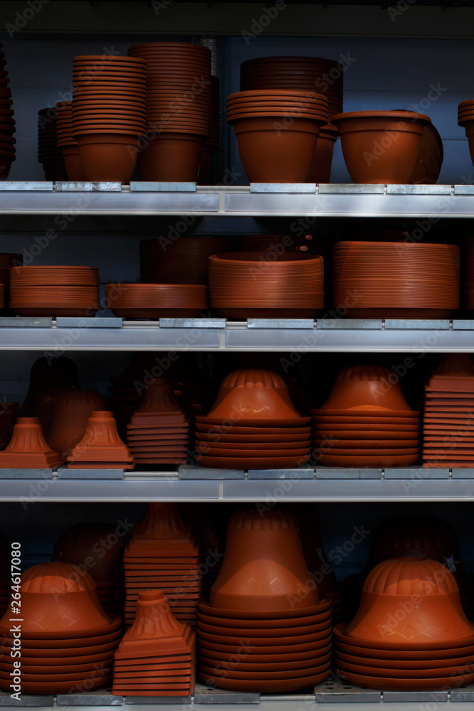 Many empty flower pots standing on the shelves Many empty flower pots standing on the shelves