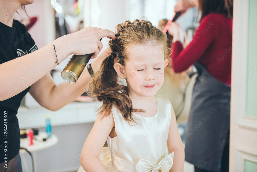 Hairdresser weaving plaits in beauty salon. Hairdressing services. Сreating  hairstyle. Hair styling process. Children's hairdressing salon. Stock Photo  | Adobe Stock
