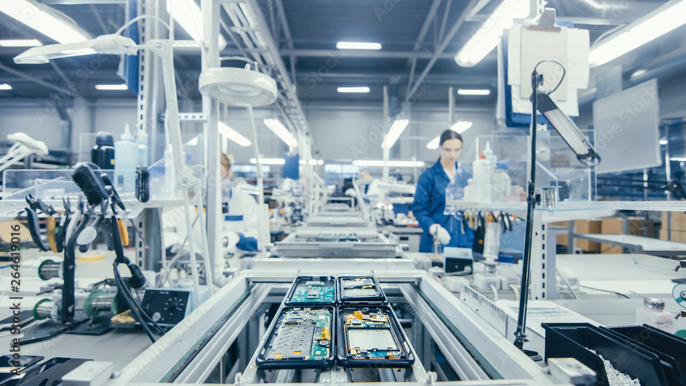 Shot of an Electronics Factory Workers Assembling Circuit Boards by Hand While it Stands on the Assembly Line. High Tech Factory Facility. - obrazy, fototapety, plakaty 