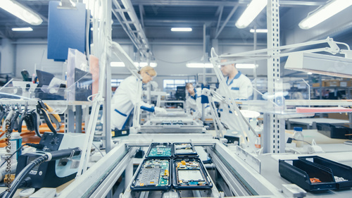 Electronics factory works at assembly line