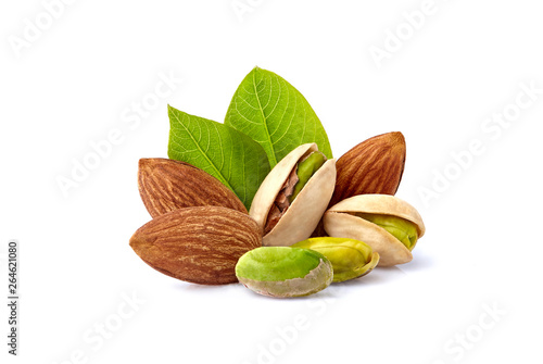 Pistachio nuts and almonds with leaves in closeup isolated