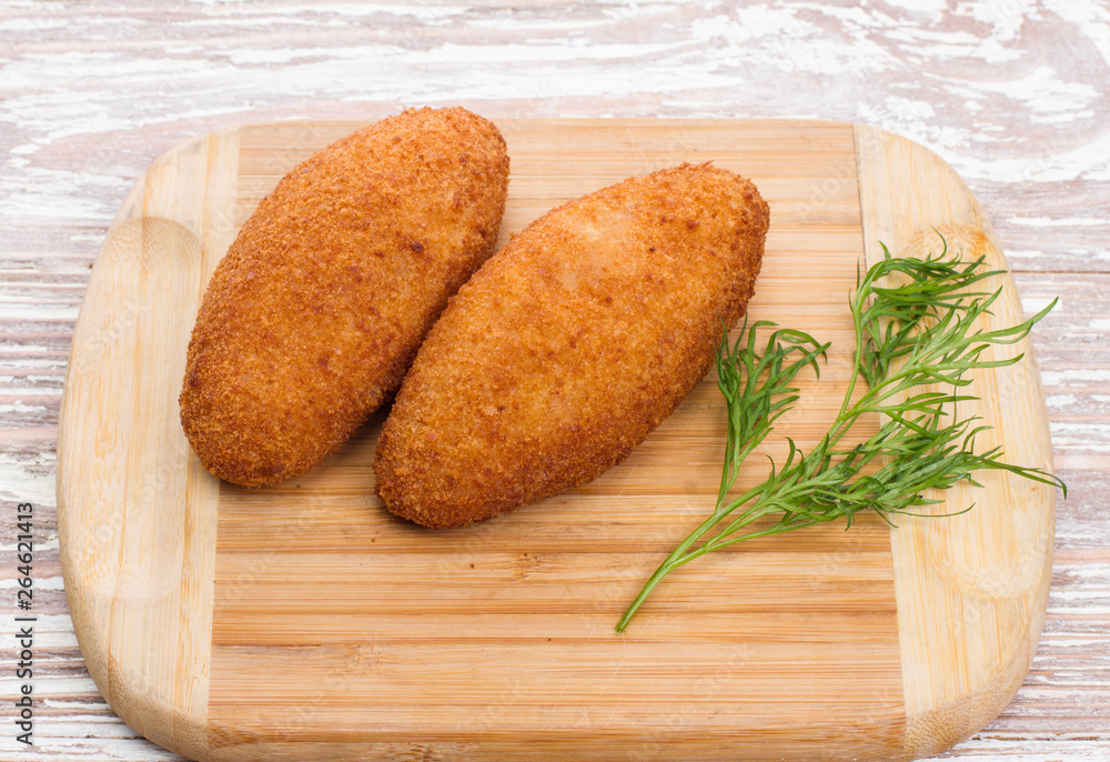 Kiev cutlets meat on wooden board Kiev cutlets meat on wooden board