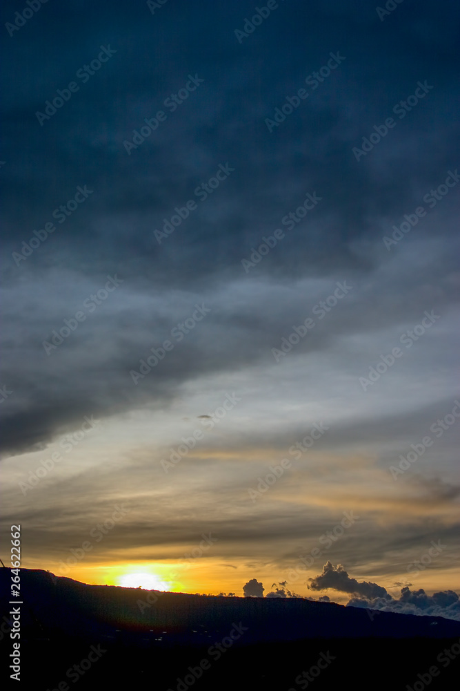 The moment of the begining of the dusk at the Andean mountains of central Colombia. - vertical.