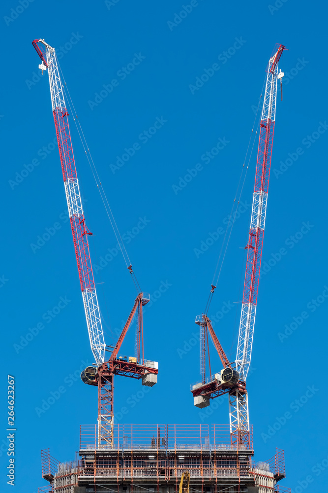 Skyscraper Construction With Cranes And Scaffolding Skyscraper Construction With Cranes And Scaffolding