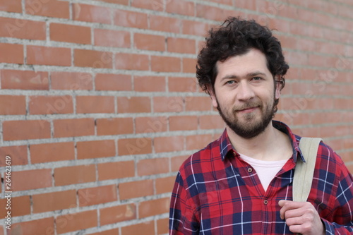 Real looking man in brick wall background photo