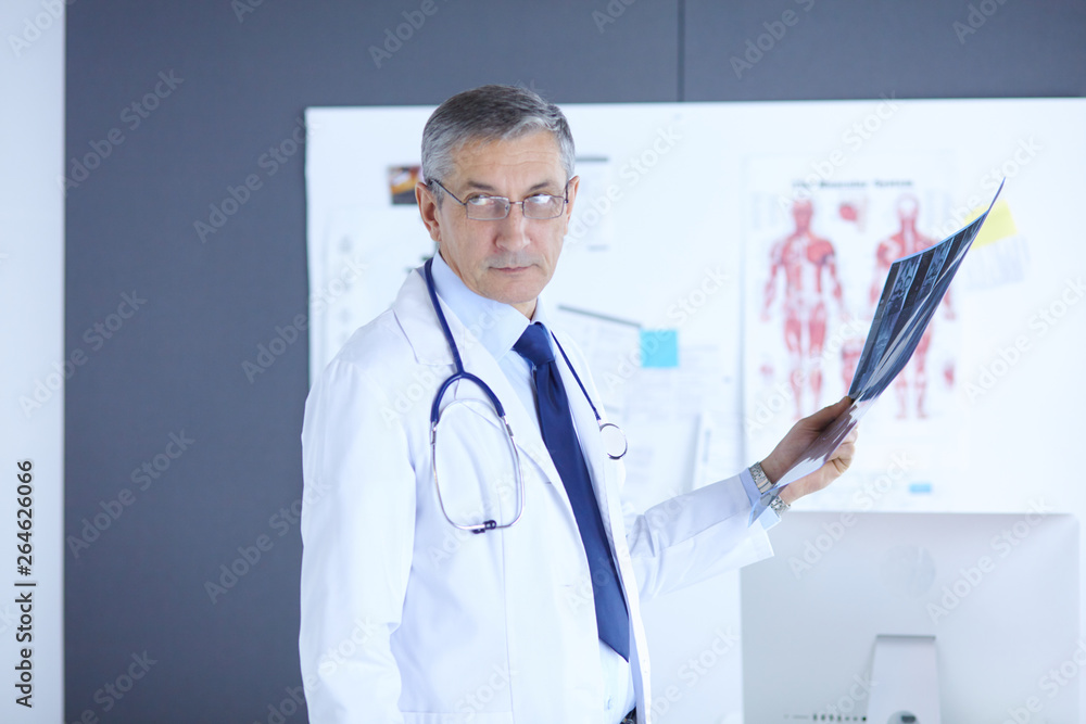 Doctor in the office examines the patient's x-ray Doctor in the office examines the patient's x-ray