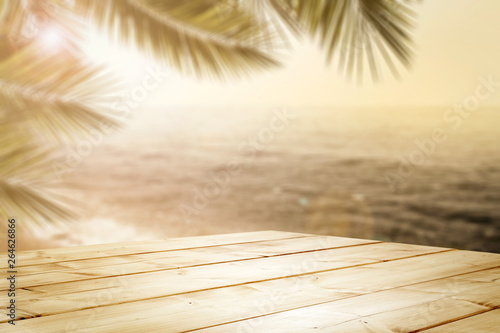 Desk of free space and summer landscape of sea beach and palms 